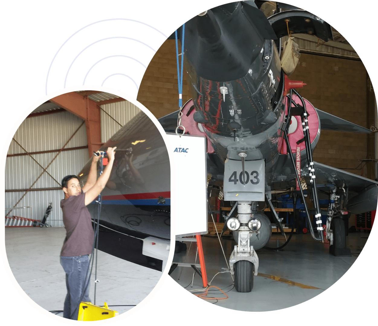 A man is working on an airplane in the hangar.